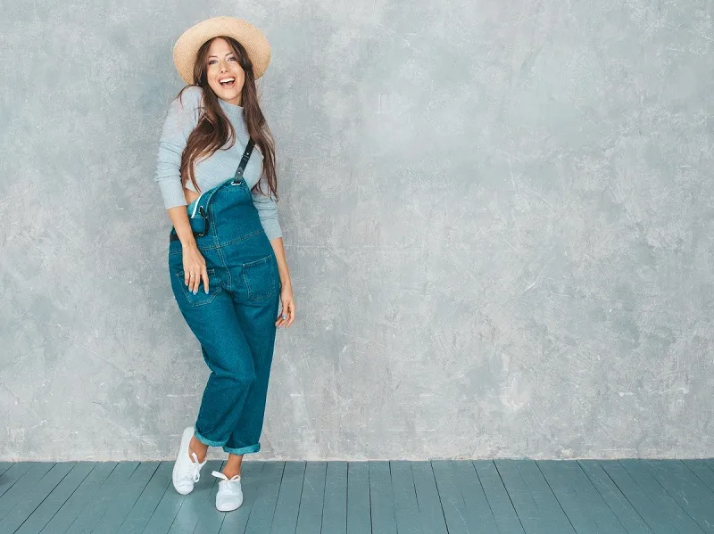 young beautiful smiling woman looking trendy girl casual summer overalls clothes hat