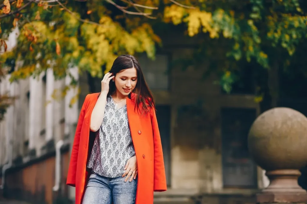 beautiful elegant girl walking around autumn city