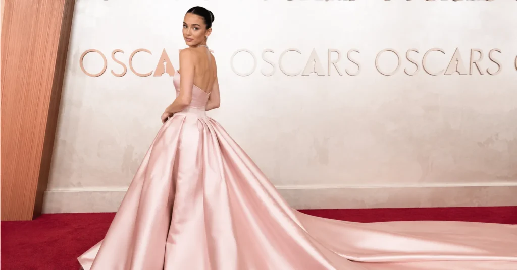 Iconic Oscars outfits featuring a glamorous actress in an elegant couture red carpet gown.
