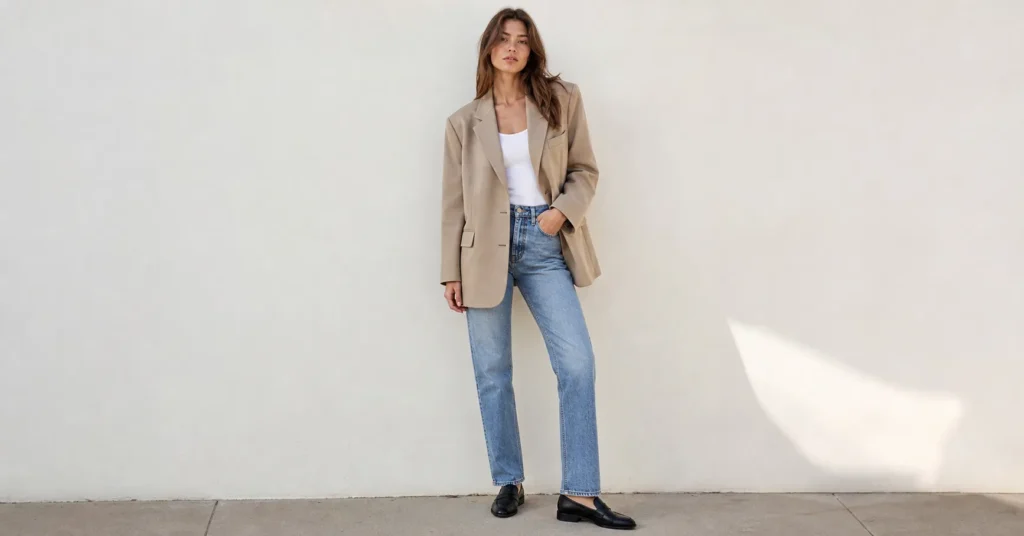 90s minimalist outfits 2026 featuring oversized blazer, white tank top, and straight-leg jeans in a clean neutral style