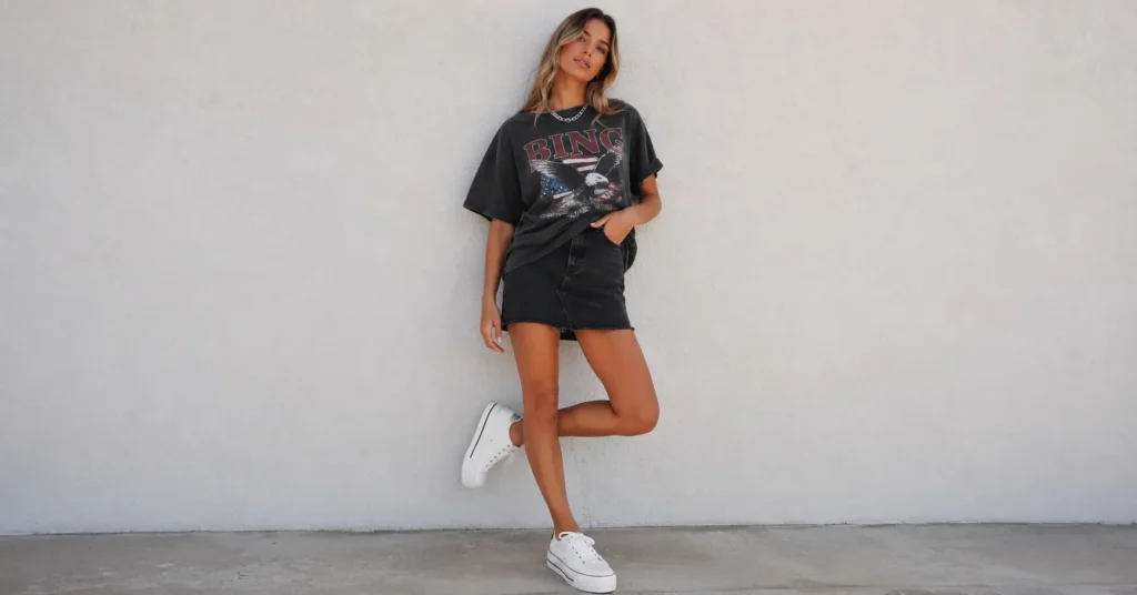 The Complete Guide to Black Skirt Outfit Ideas for Any Occasion 2 Black skirt outfit ideas featuring a casual black mini skirt and graphic tee street style look.