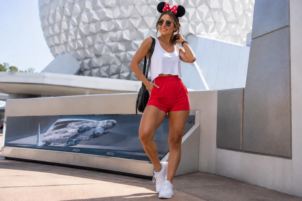 Woman wearing comfortable summer epcot outfit ideas with athletic shorts and sneakers.