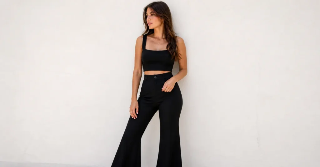 Woman wearing flared pants and crop top styled for a trendy Latin concert outfit