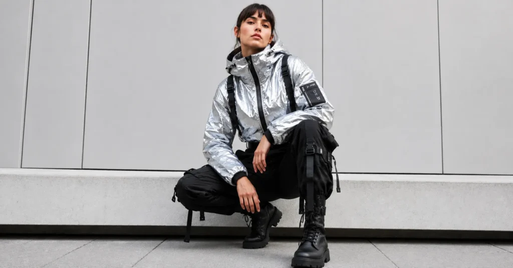 Reflective techwear jacket styled in futuristic cyberpunk outfits with chunky boots.