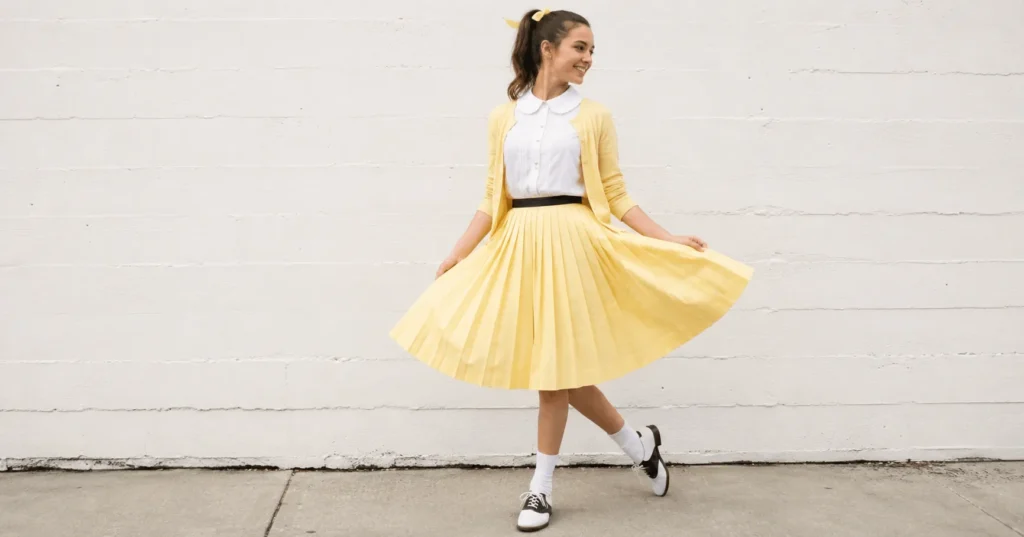Classic good girl grease outfit ideas with pastel skirt and vintage cardigan.