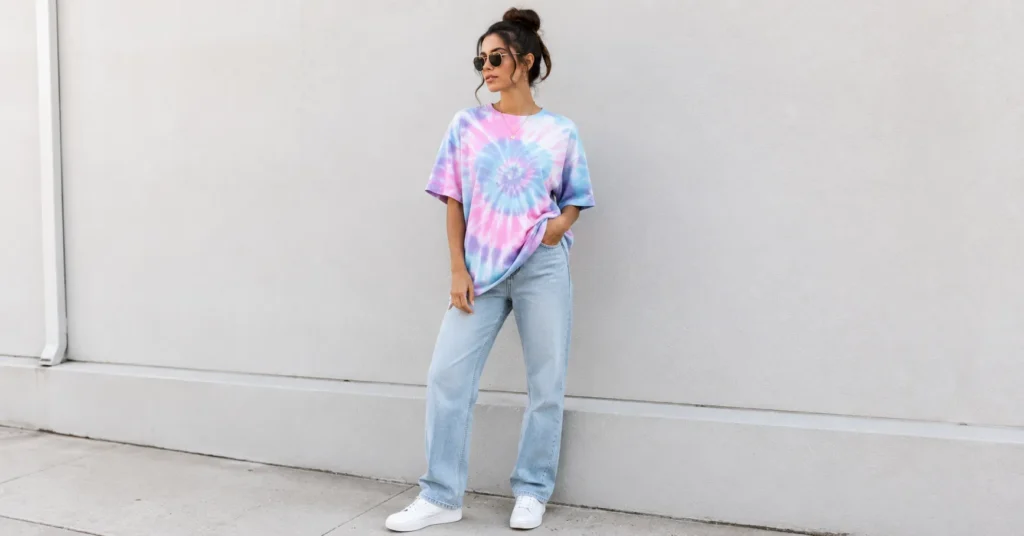 The Complete Guide to Styling Tie Dye Outfits for Every Season 3 Tie dye outfits featuring a pastel tie-dye t-shirt styled with jeans and white sneakers.