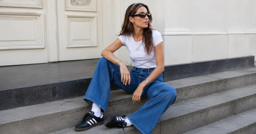 Casual samba adidas outfit with wide-leg denim jeans and a white t-shirt for everyday style.