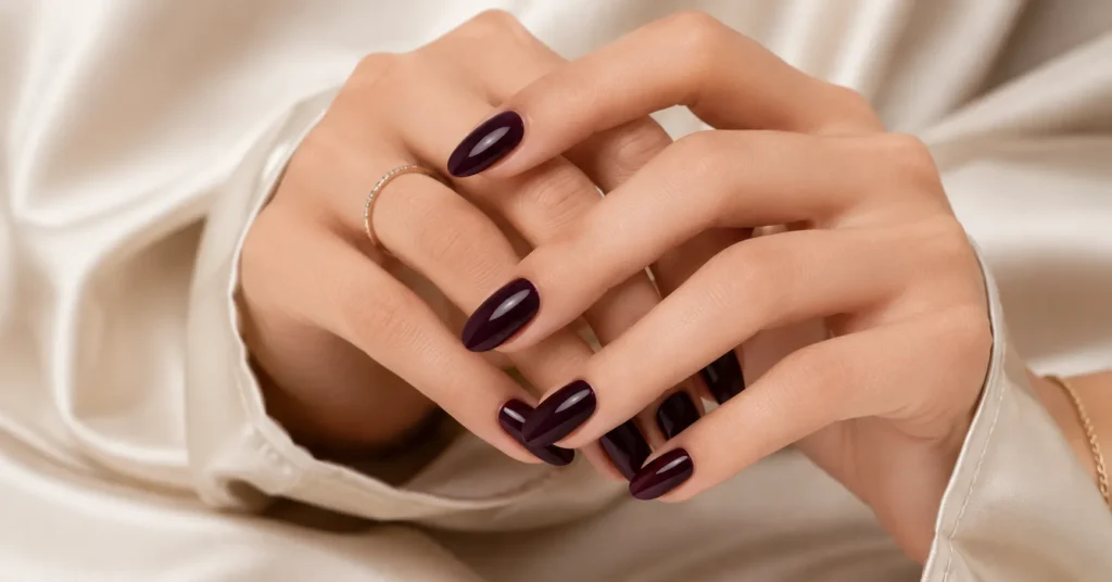 Dark winter nail colours with deep plum nails and near-black purple manicure shades.
