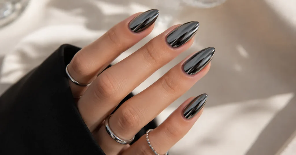 Black chrome nail art ideas with metallic shine and futuristic manicure style.