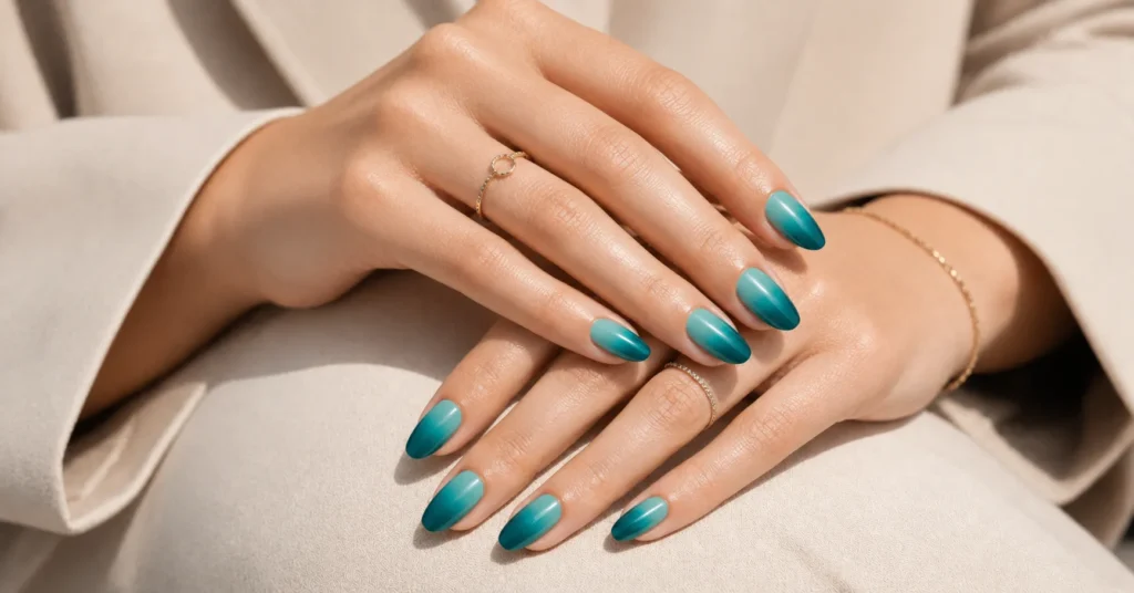 Teal Nail Trends 2026 featuring teal ombré nails with a glossy gradient manicure design.