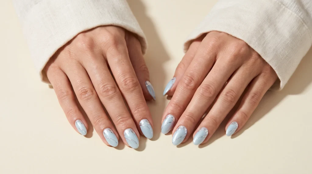 Icy Blue Nails: 10 Stunning Ideas, Shades & Pro Tips for a Frosty Manicure 10 Elegant icy blue nails detailed with delicate silver foil accents and bright highlights.