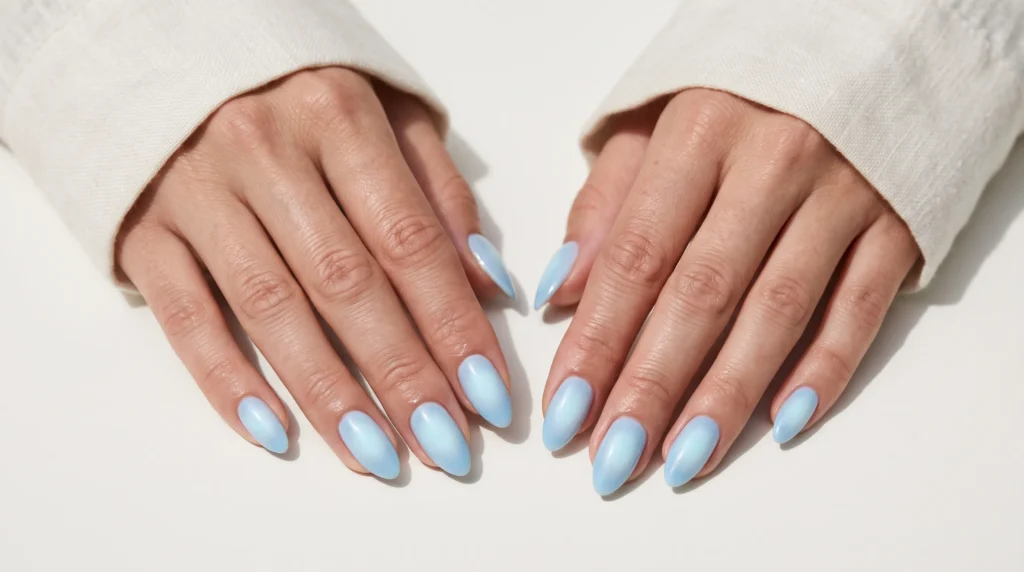 Icy Blue Nails: 10 Stunning Ideas, Shades & Pro Tips for a Frosty Manicure 11 Airbrushed glowing aura design featuring soft pale icy blue nails.